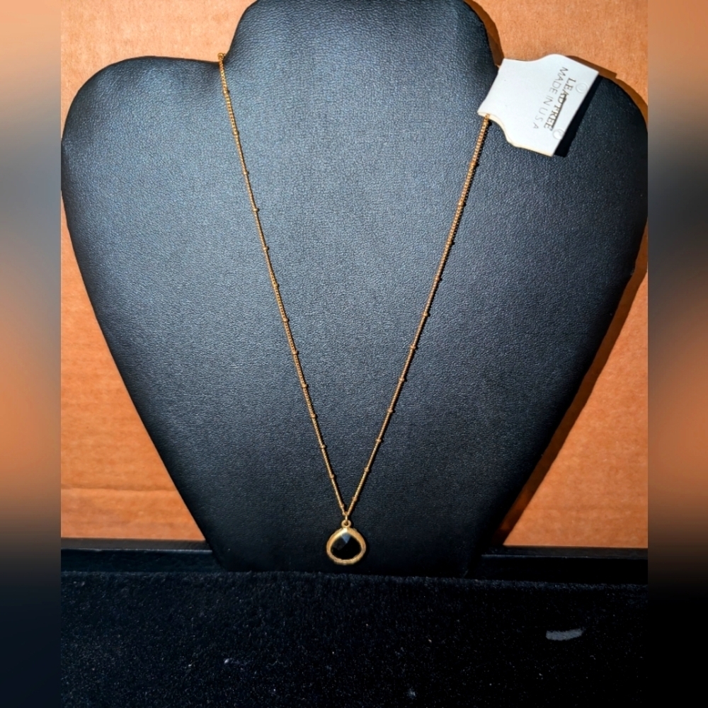 beaded chain necklace with a black gemstone at the base